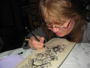 Vikki Soros working on a paddle artwork donation for the Sudbury Theater Center